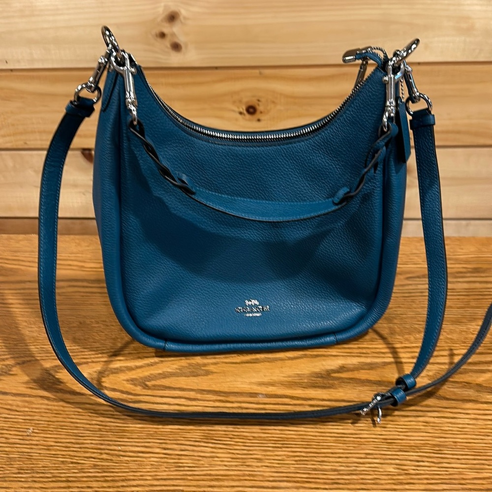 Teal Coach purse with both hand and shoulder strap.